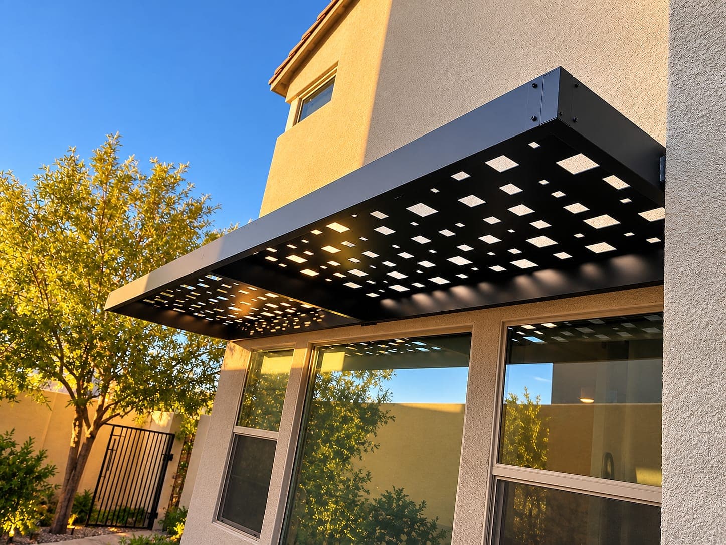 Black awning with Square design Soleil panels over a window