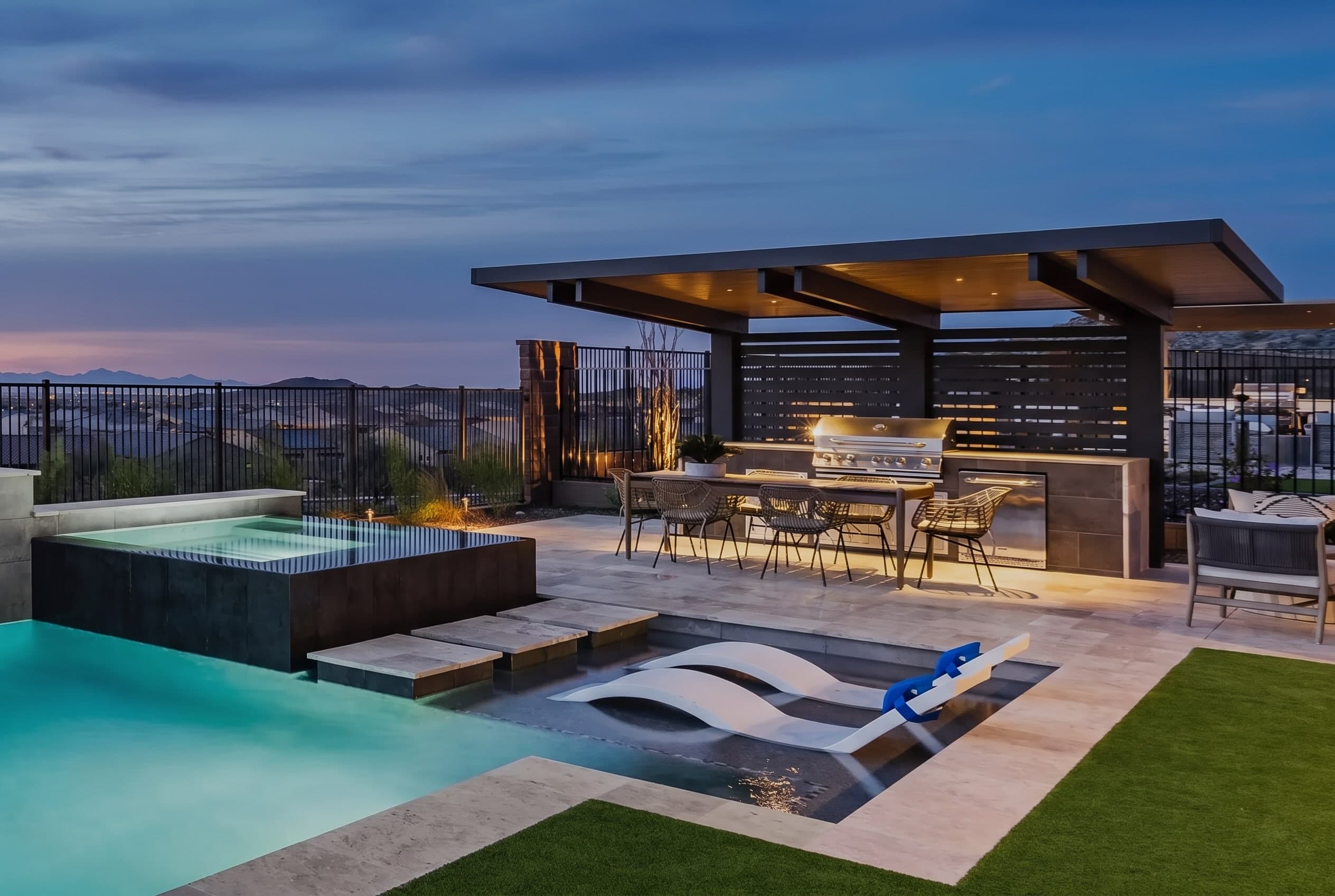 4K Aluminum pergola over an outdoor kitchen and pool at twilight