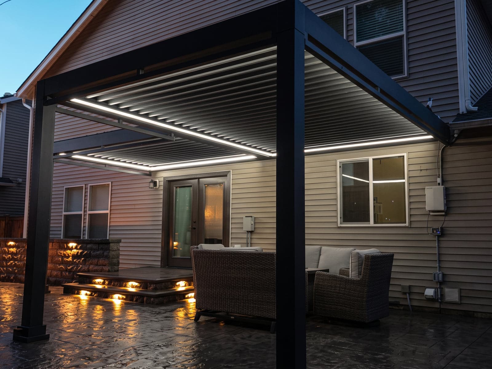 Louvered roof over a back patio at dusk, outlined with white LED strip lights.