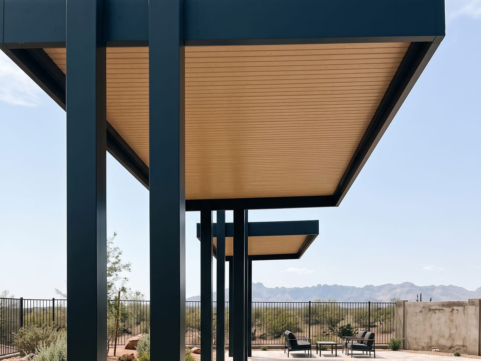 Row of cantilever covers with Sandalwood VEER-Batten panels over a stone patio